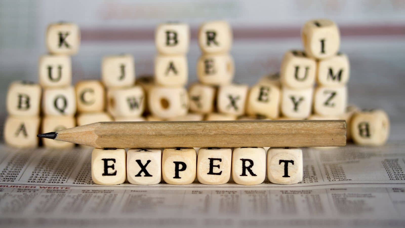 image of block letters spelling expert and pencil