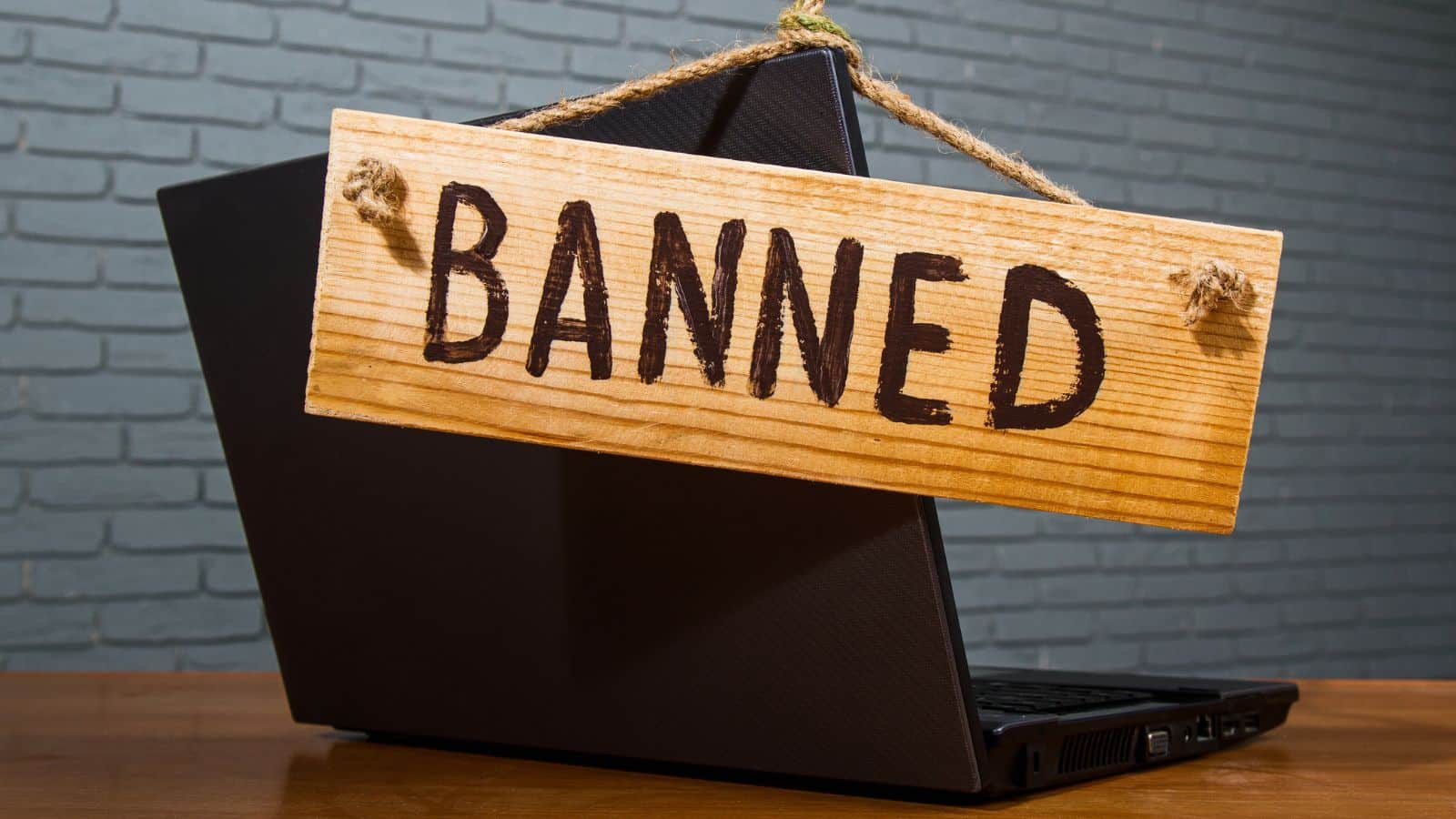 laptop with a sign that says BANNED