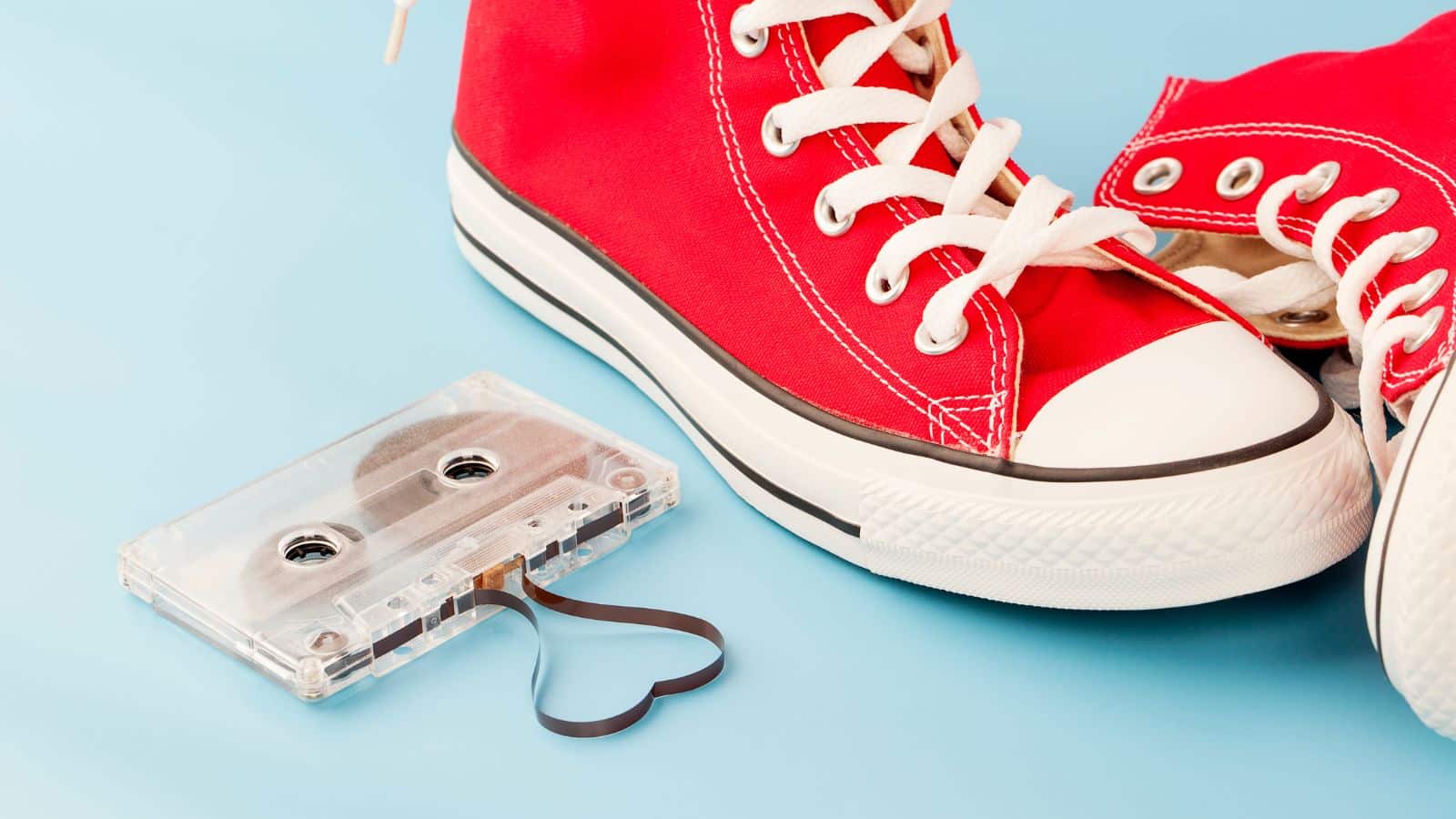 Image of red sneakers sitting next to a cassette tape